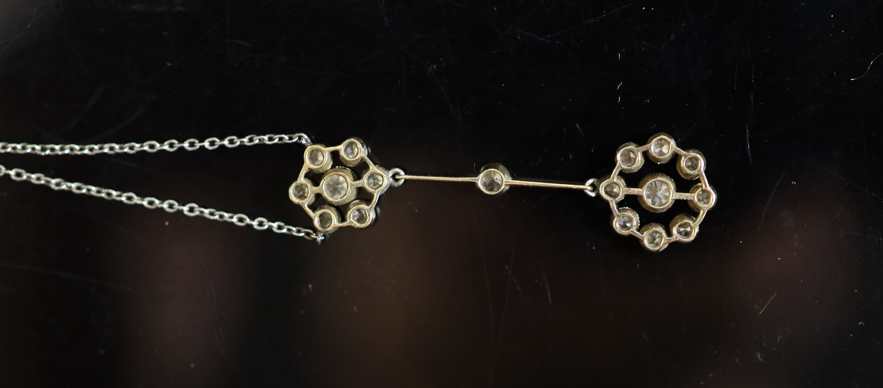 An early 20th century gold, platinum and millegrain set old round cut diamond double cluster drop pendant necklace